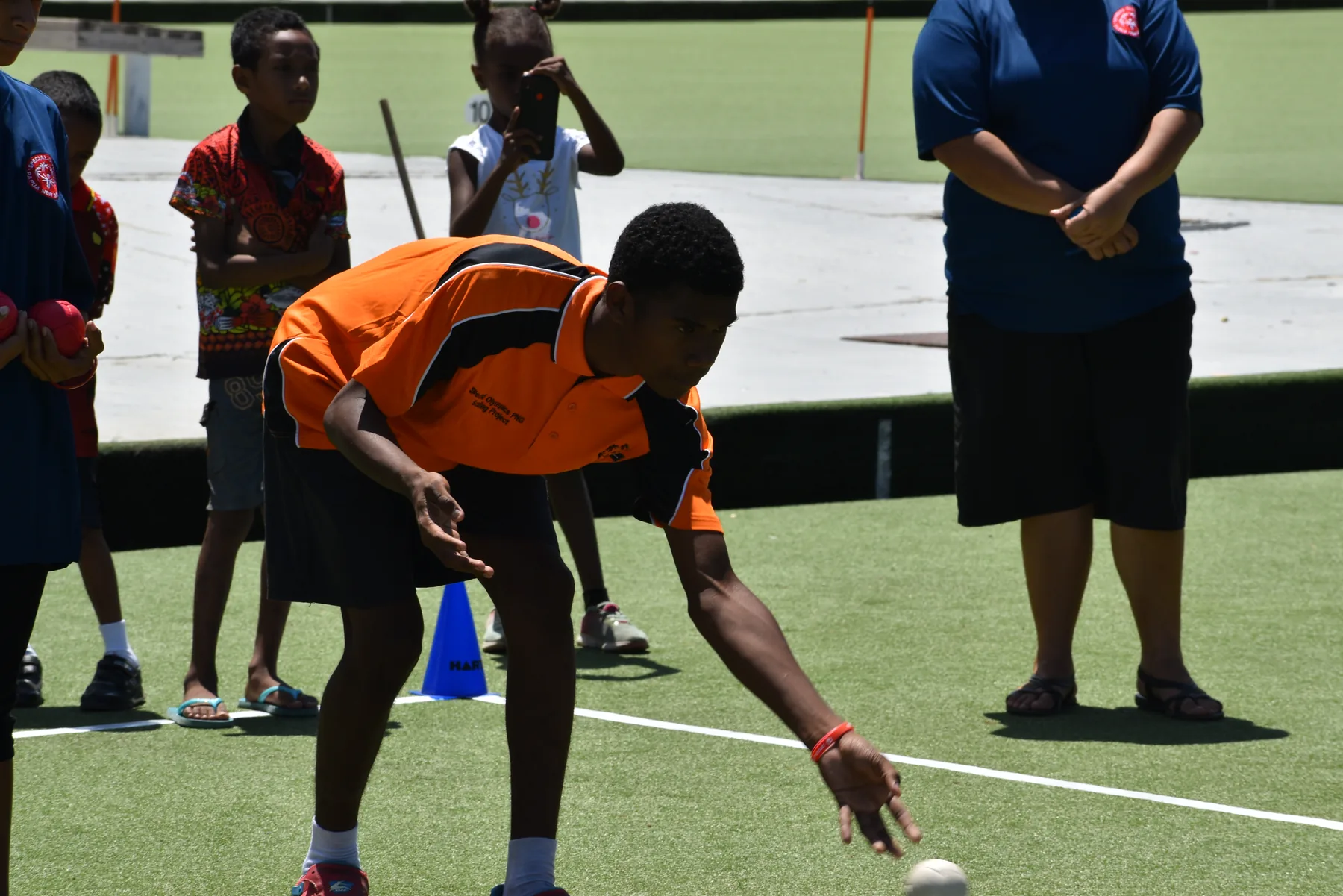 An athlete reaches for a ball during a sports activity