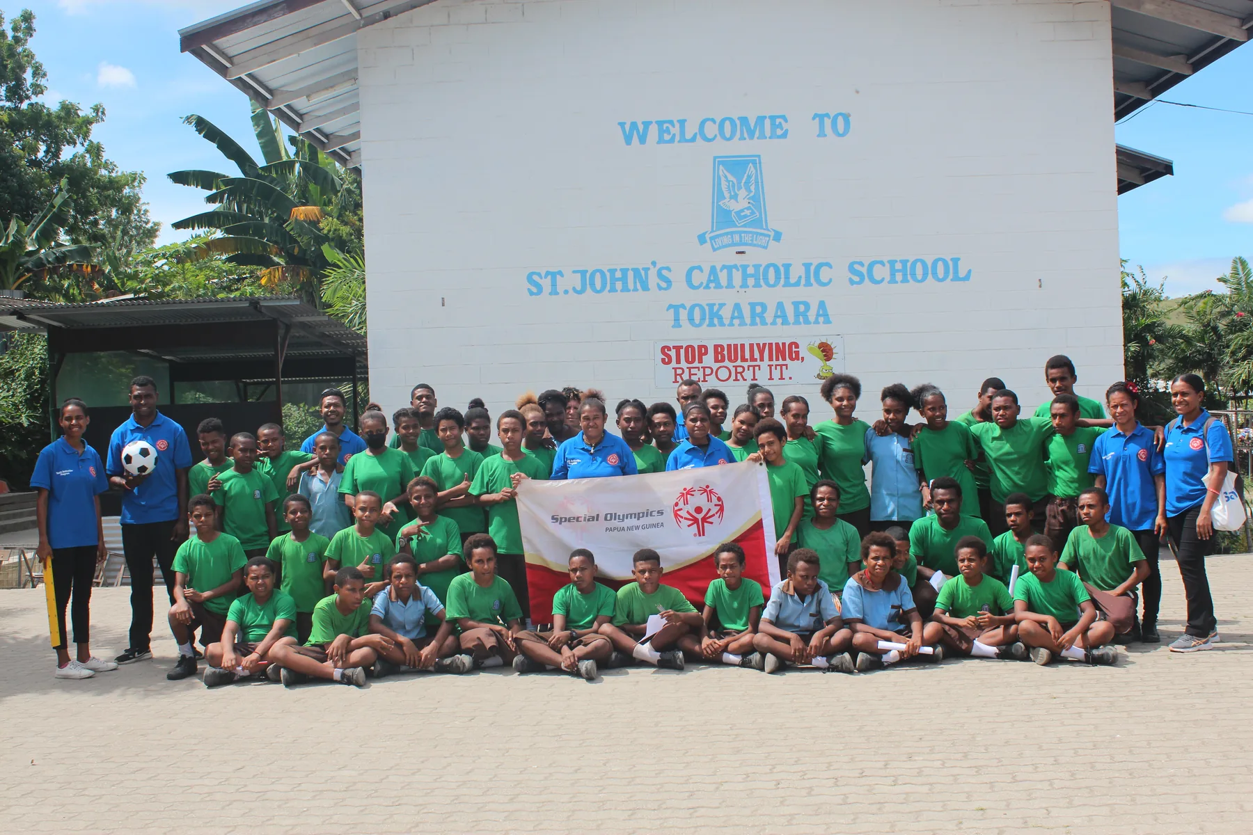Athletes and supporters gather outside a community sports venue