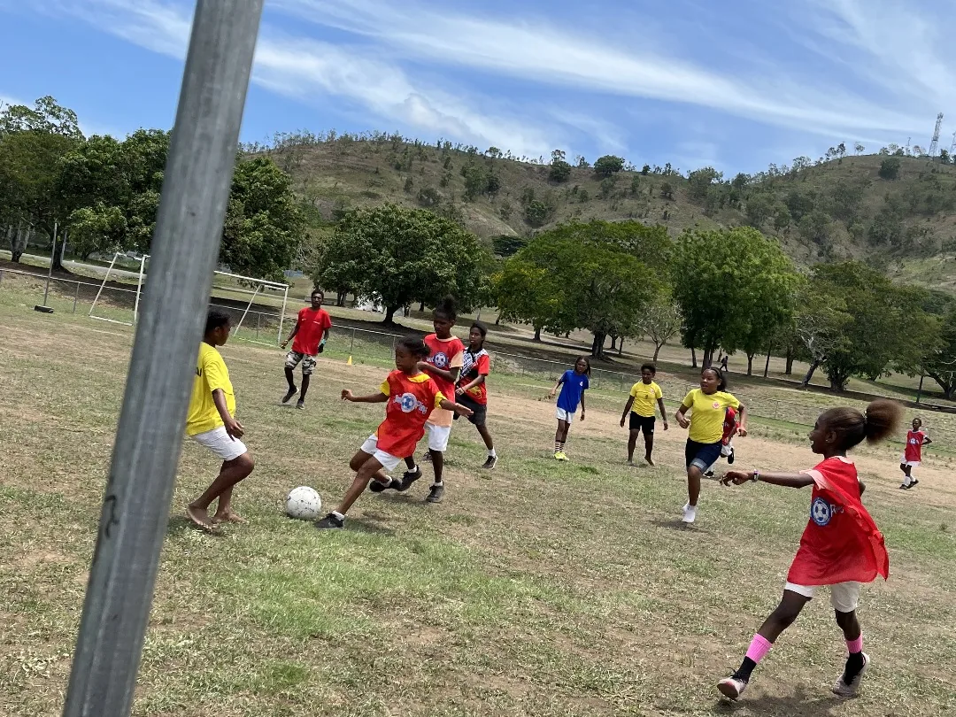 Athletes move together on a community sports field