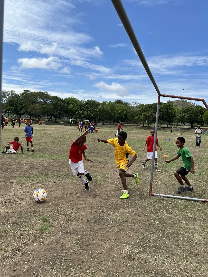 Athletes play football together in a community sports activity